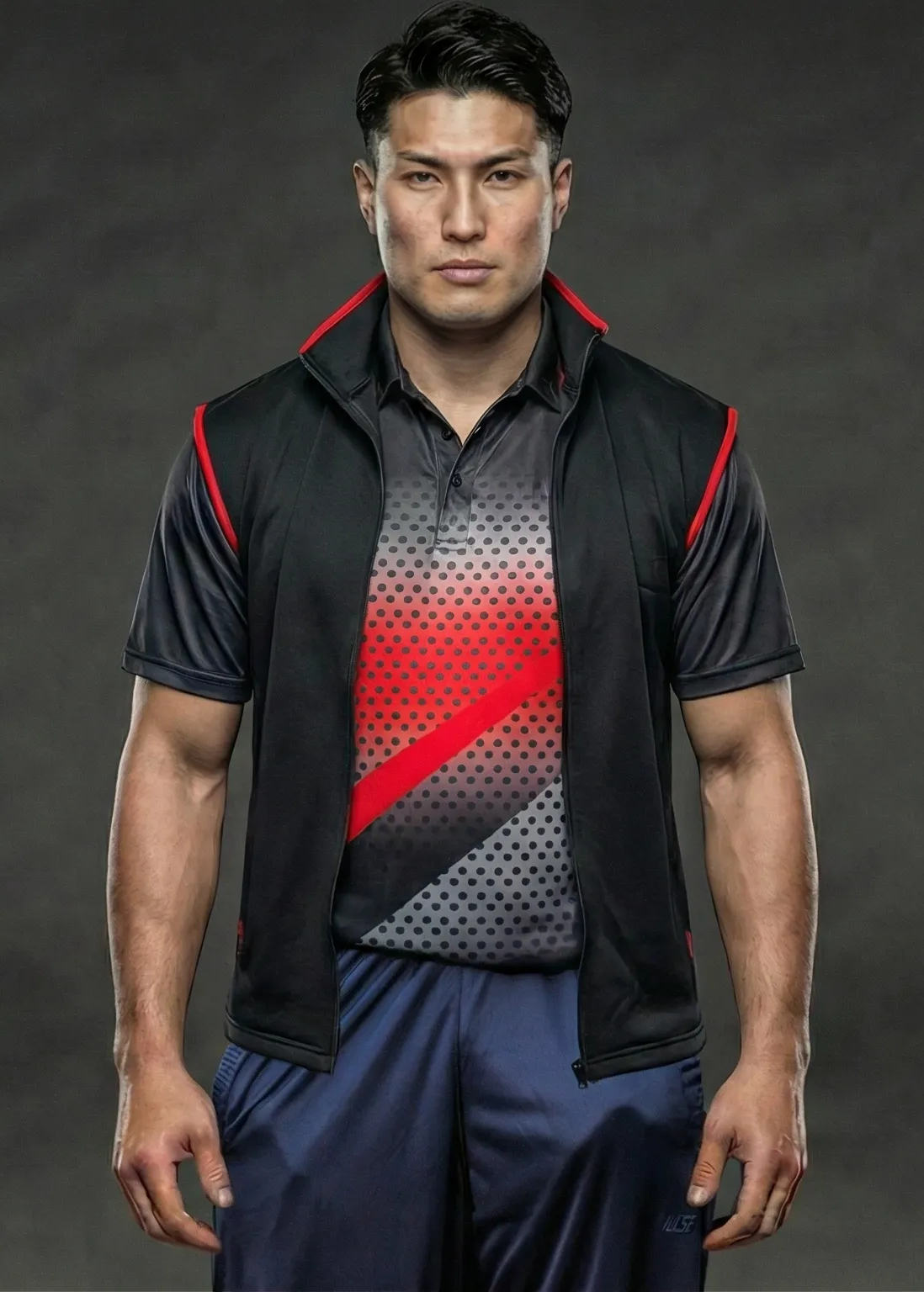 Man wearing a black and red sports outfit on a dark background