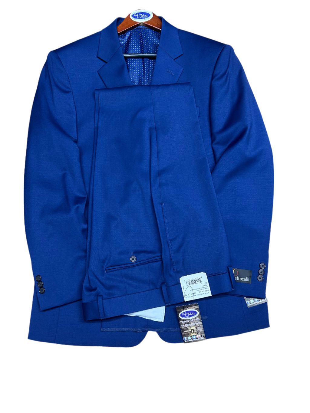 cobalt Blue jacket with a tag on a wooden surface