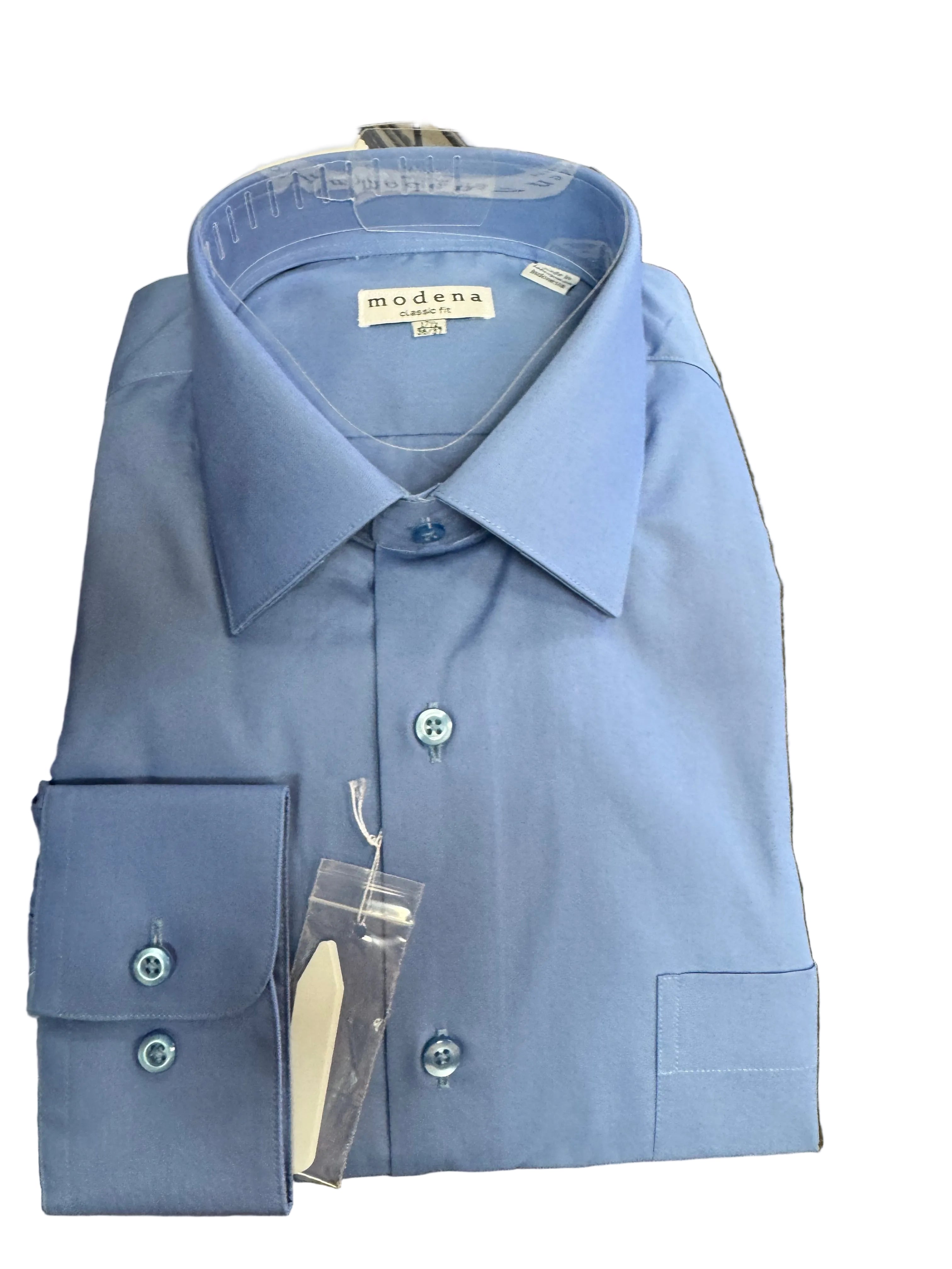 Blue dress shirt with a tag on a surface