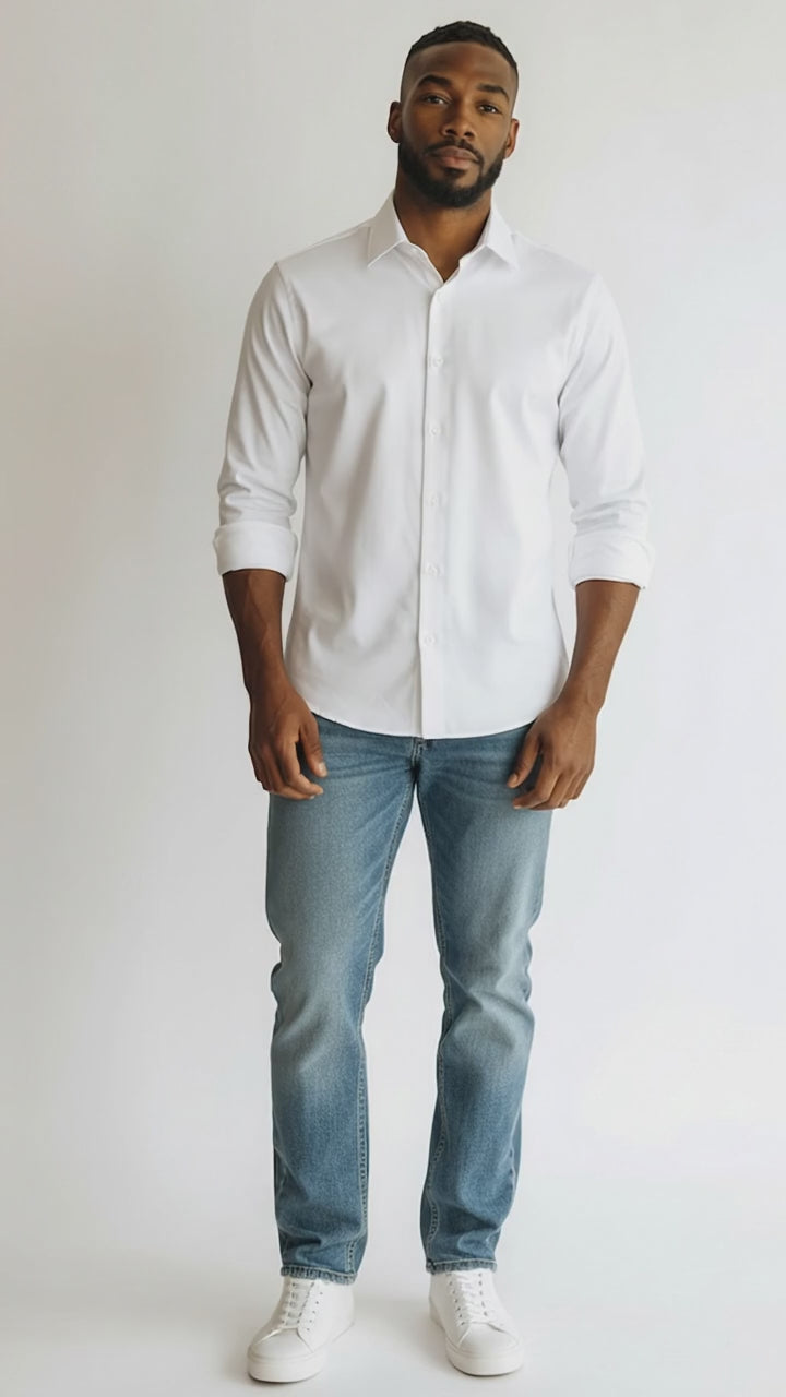 man wearing a white dress shirt and blue jeans