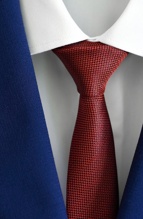 Red patterned tie on a mannequin with a white shirt and cobalt blue suit at lil johns